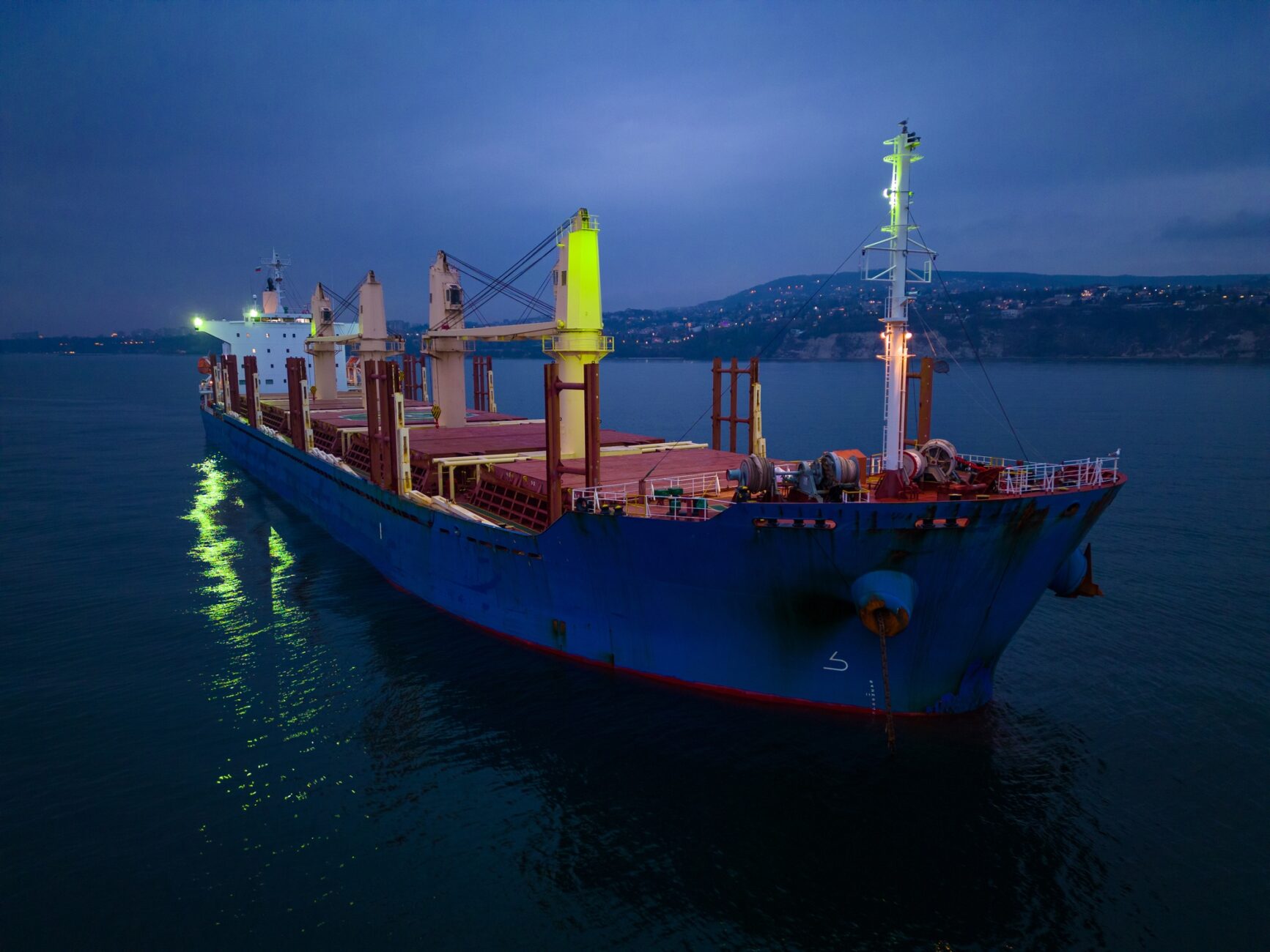 Aerial view cargo bulk carrier ship on the sea at night