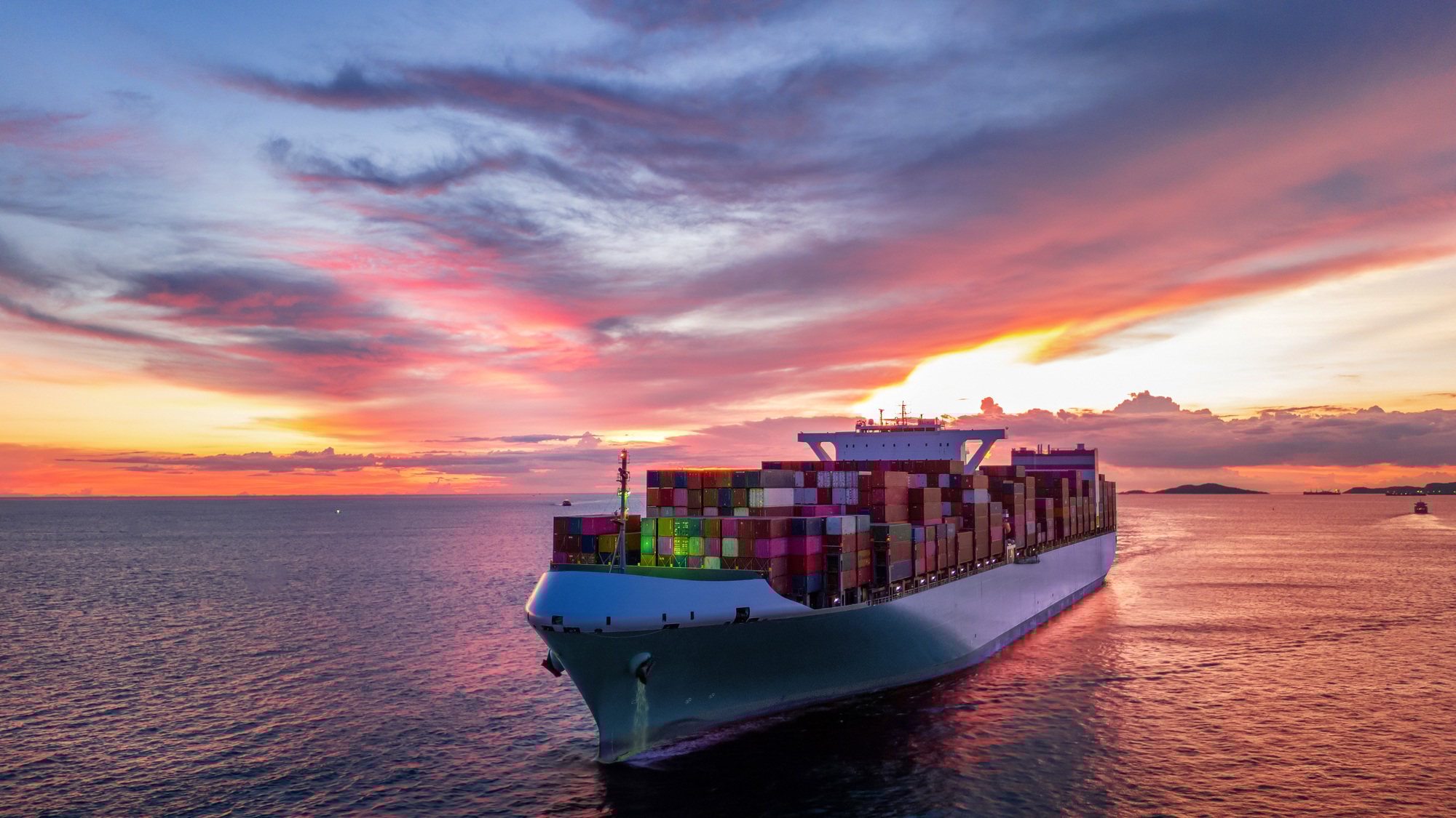 Cargo Container Ship at sunset in the ocean ship carrying container and runnin