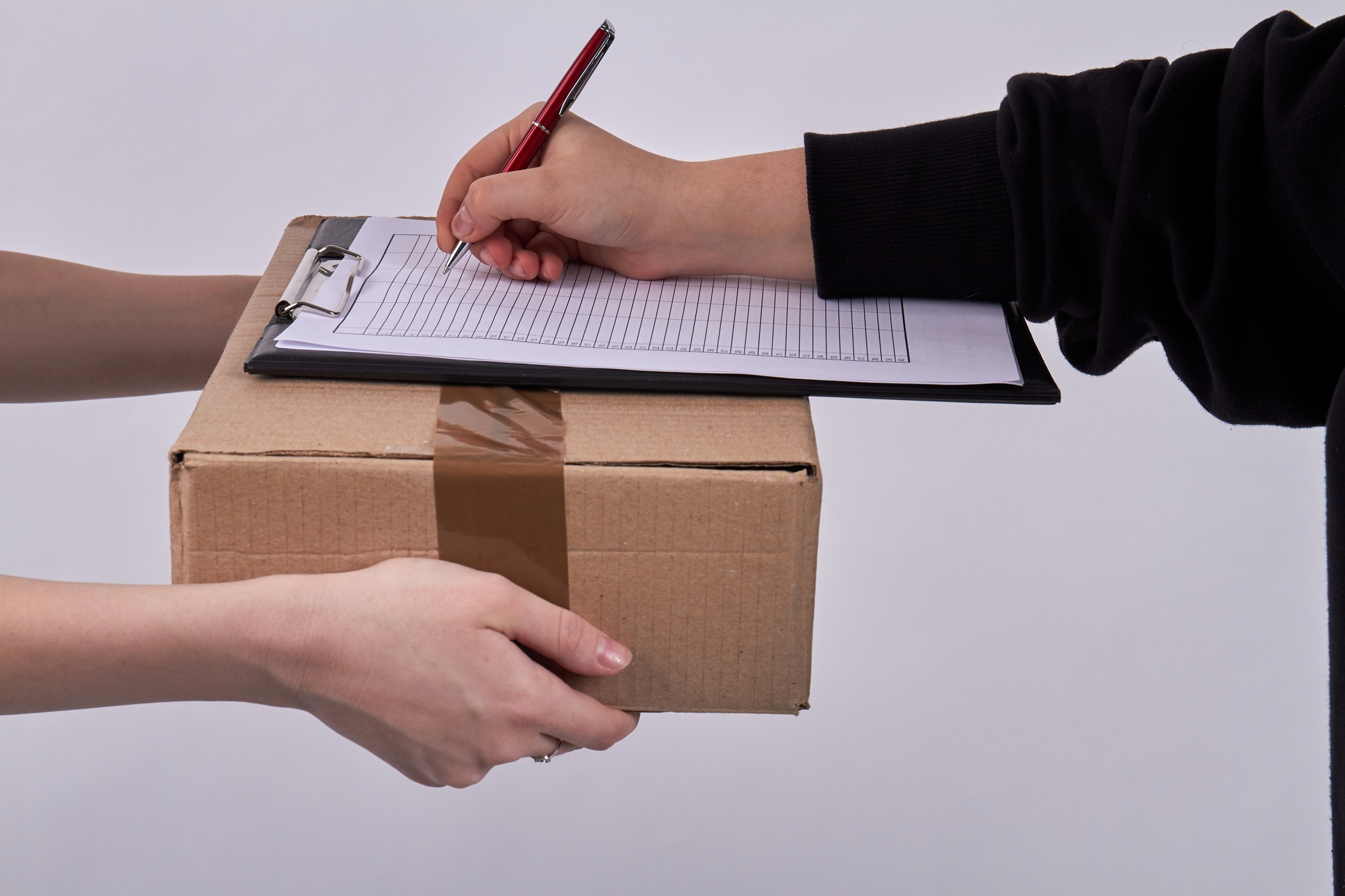 Customer signing receipt of delivery package.